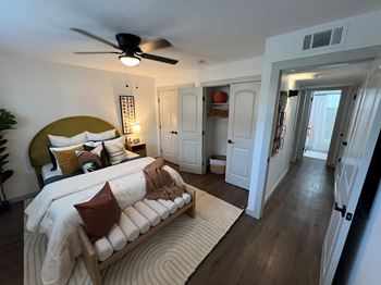 A bedroom with a bed and a couch.at Century Apartments, Memphis, TN 38117  